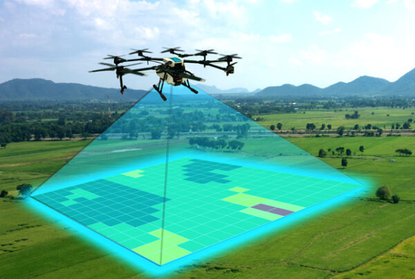 NGC | A drone flies over fields, scanning and mapping the area below with a digital overlay displaying analyzed land sections.