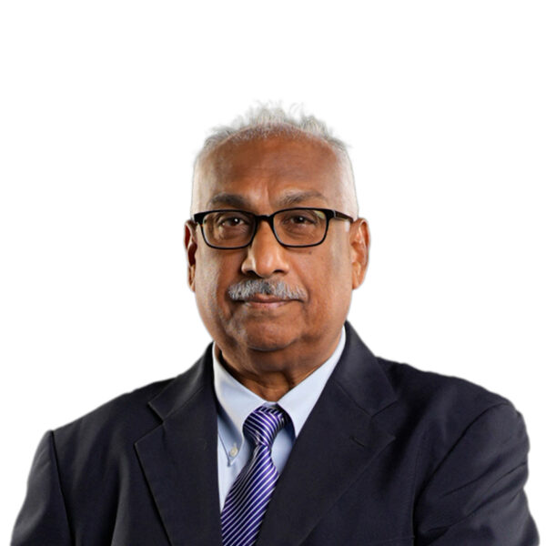 NGC | An older man wearing glasses, a dark suit, light blue shirt, and striped tie stands against a plain white background, reflecting experience in corporate governance and company leadership.