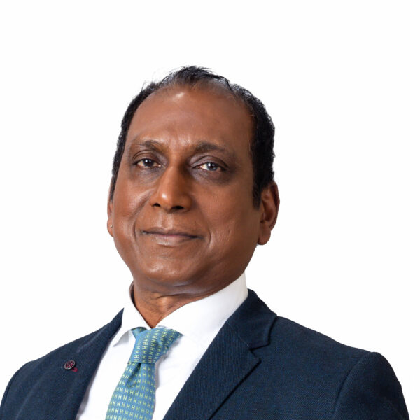 NGC | A man in a dark suit, white shirt, and patterned tie poses against a plain white background, embodying the professionalism expected of board members and leaders in corporate governance as he looks directly at the camera.